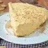 Delicious slice of Pumpkin Fluff Pie topped with whipped cream and autumn spices.