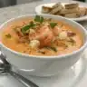 A bowl of crab and shrimp seafood bisque, a creamy and luxurious soup